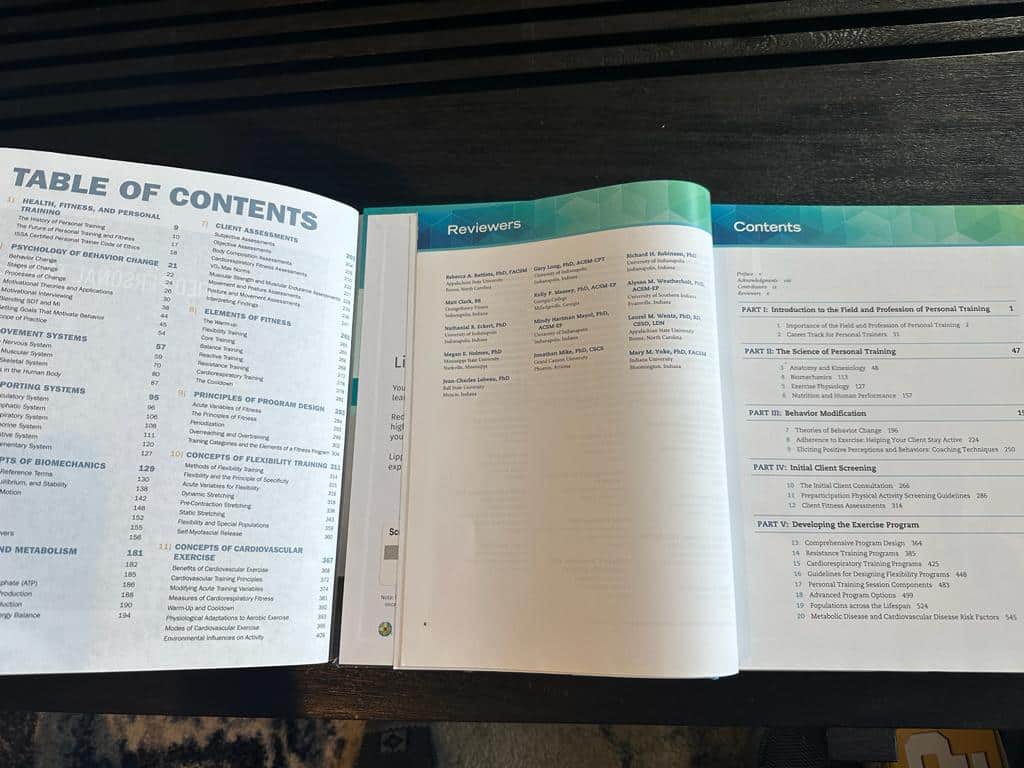 ISSA vs ACSM - Which Fitness Certification is Best? 48 ISSA and ACSM textbooks open to table of contents - course layouts
