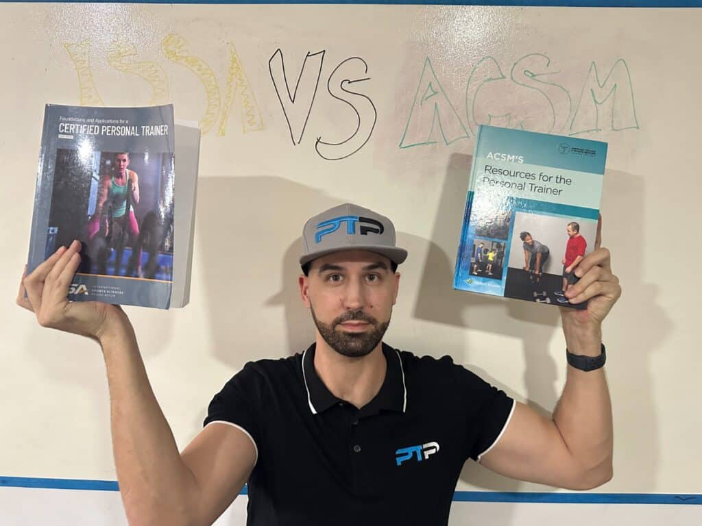ISSA vs ACSM - Which Fitness Certification is Best? 43 Tyler Read holds up ACSM and ISSA textbooks against a whiteboard saying ISSA vs ACSM
