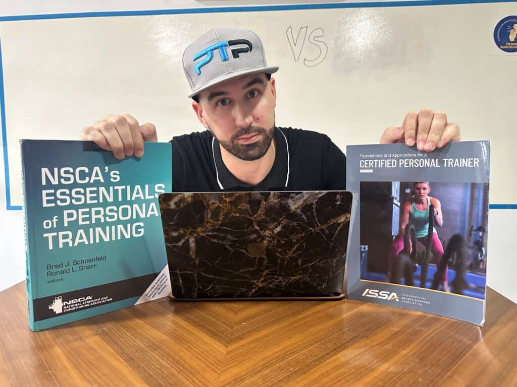 VIDEOASK TEST 6 Tyler Read holds NSCA and ISSA textbooks up on table with whiteboard in the back - which is better, NSCA VS ISSA