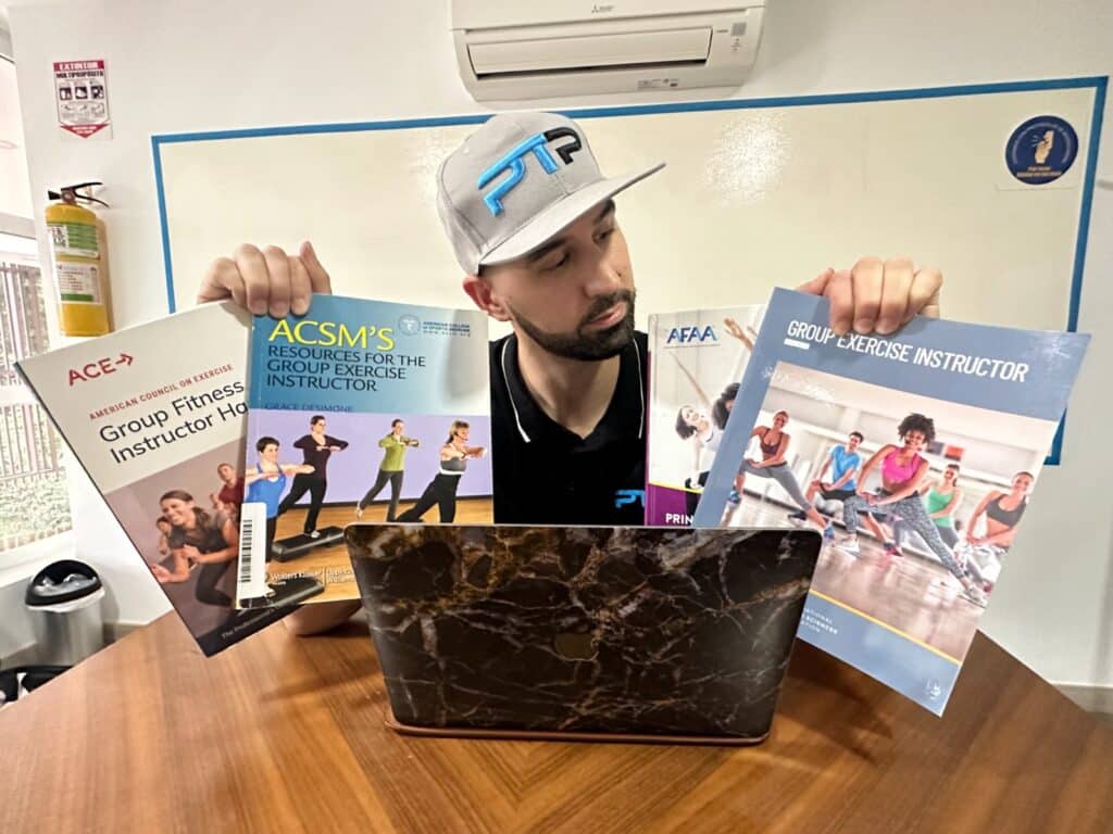 How to pick the best group fitness certification (Updated) 22 Best group fitness certifications. Tyler Read holds up the textbooks of the best group fitness instructor certifications - which group exercise certification is the best?