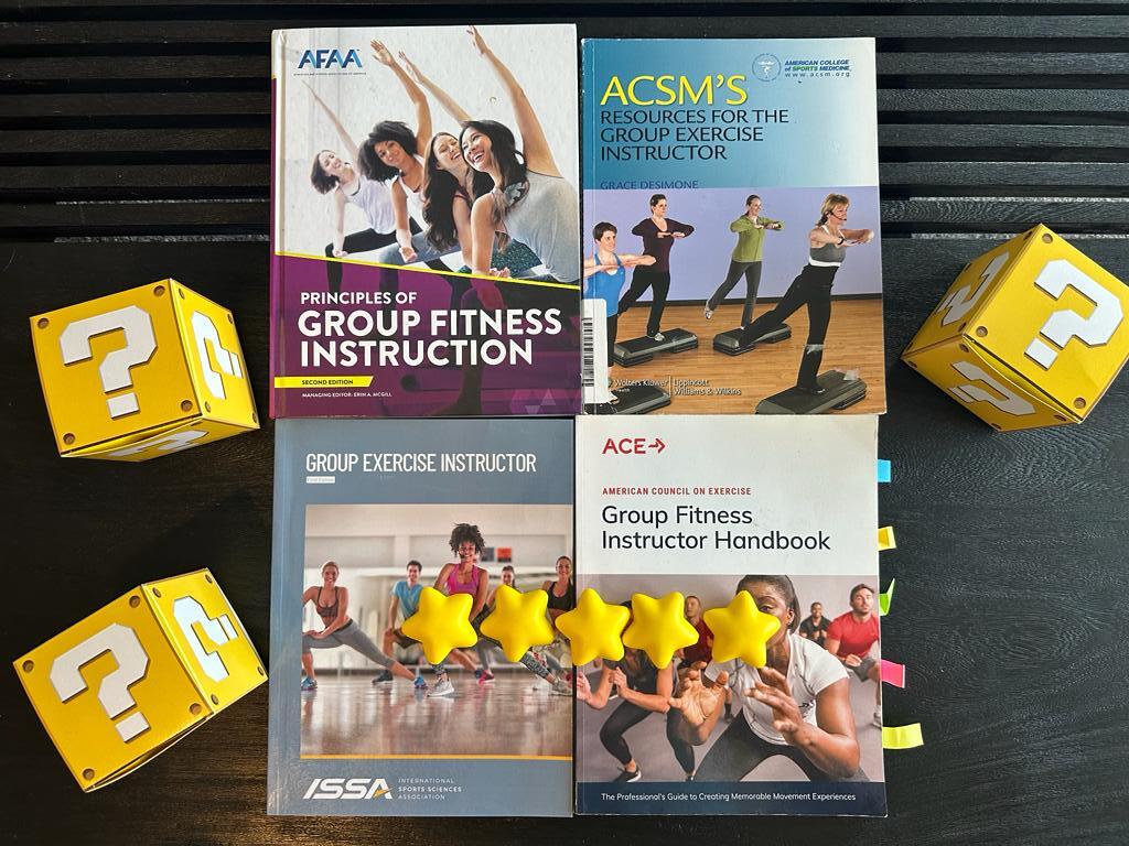 How to pick the best group fitness certification (Updated) 41 best group fitness certifications - GFI textbooks on table with yellow question mark boxes - which is the best gfi