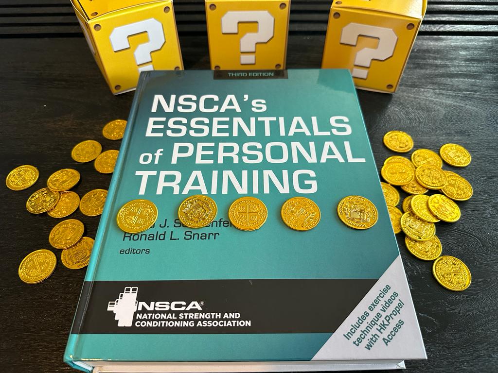 Cheapest personal trainer certification guide (Updated) 39 Cheapest personal training certifications - NSCA textbook laid out on table with gold coins and mystery boxes - how much does NSCA CPT cost?
