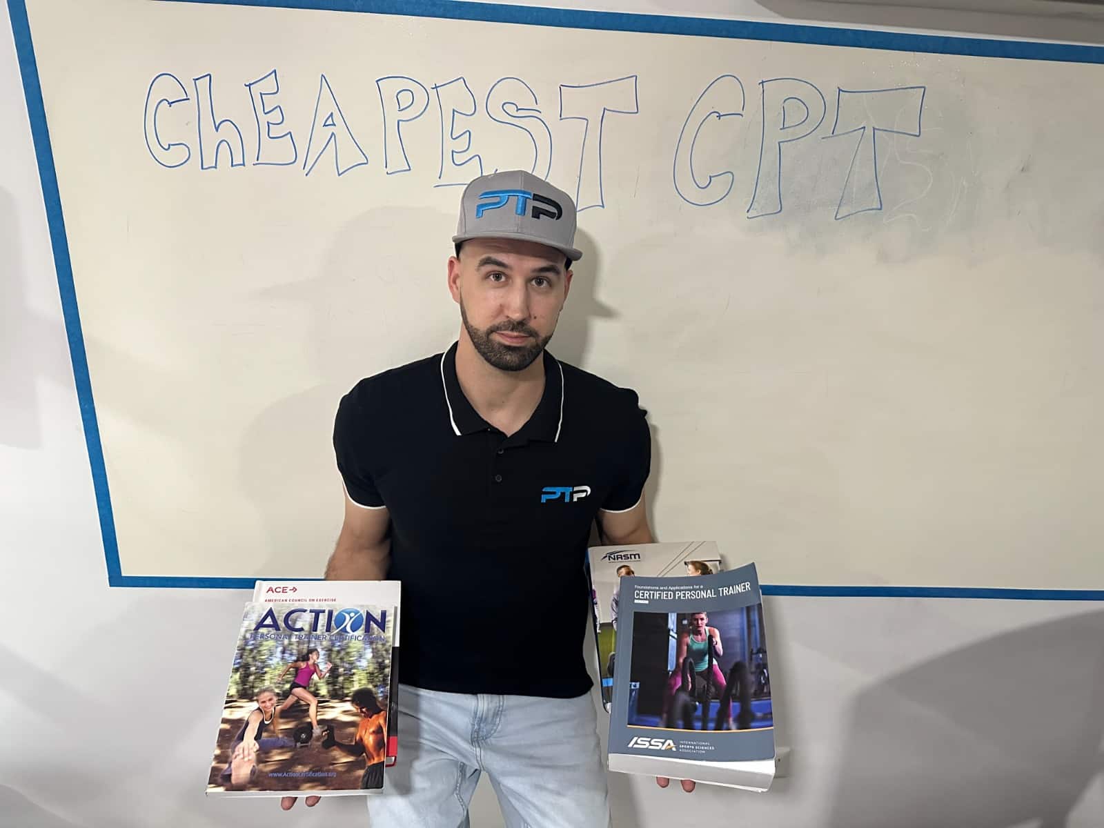 Cheapest personal trainer certification guide (Updated) 24 Tyler Read holds up the cheapest personal trainer textbooks against a while board with "cheapest CPT" on it