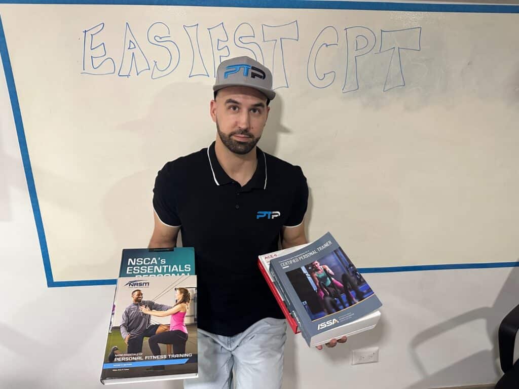 Easiest personal trainer certification guide (Updated) 27 Easiest personal training certifications review. Tyler Read holds the textbooks in front of white board saying easiest cpt