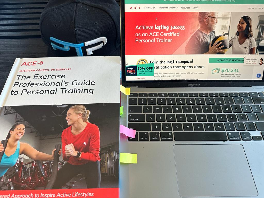 Best online personal trainer certification guide (Updated) 42 best online personal training certification - ace cpt textbook next to laptop with ace website and ptpioneer hat