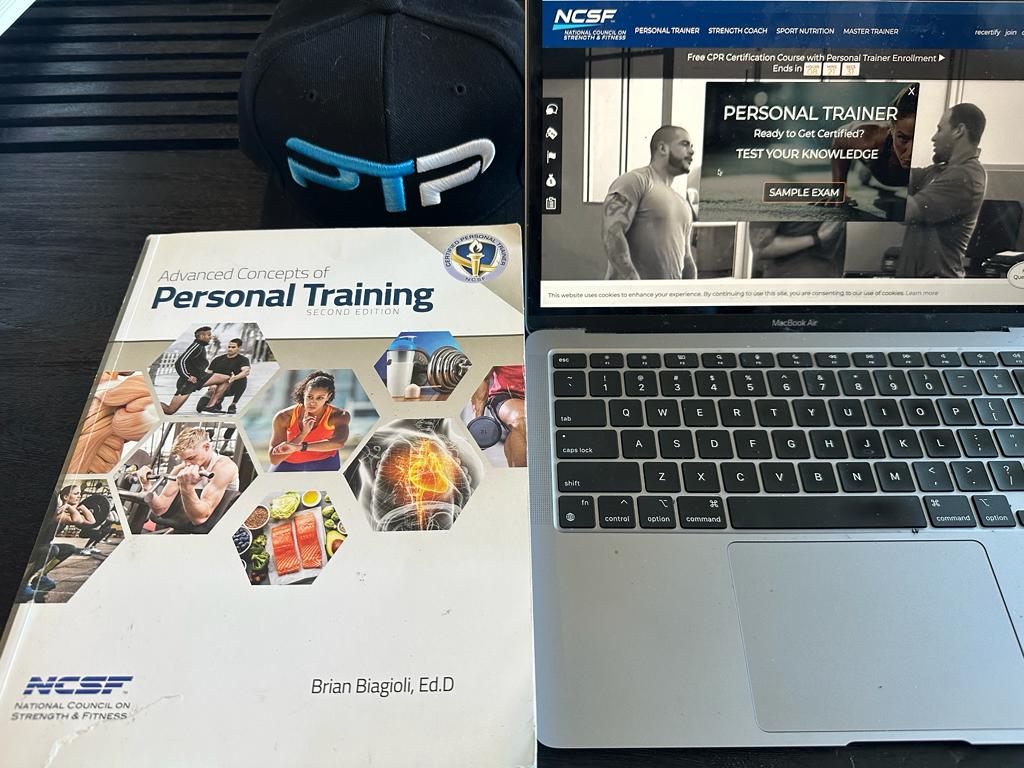 Best online personal trainer certification guide (Updated) 40 best online cpts - ncsf personal training textbook next to laptop showing ncsf website and ptpioneer hat