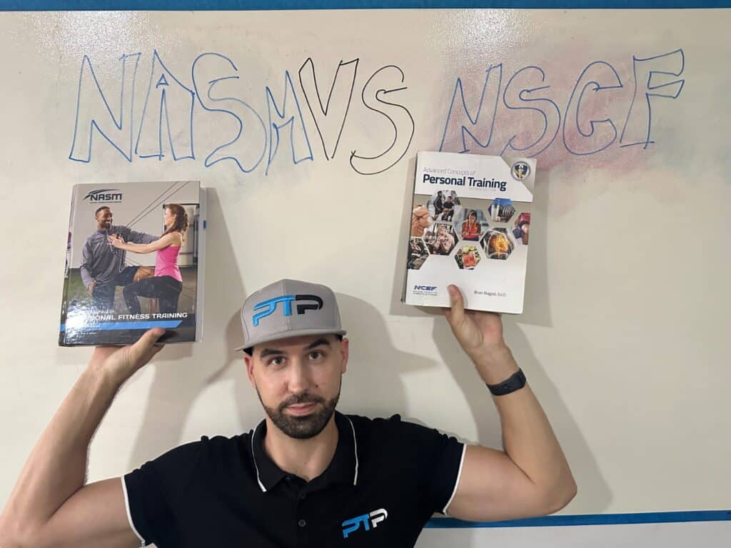 NASM vs NCSF - Tyler Read holds up NCSF and NASM textbooks against white board with lettering