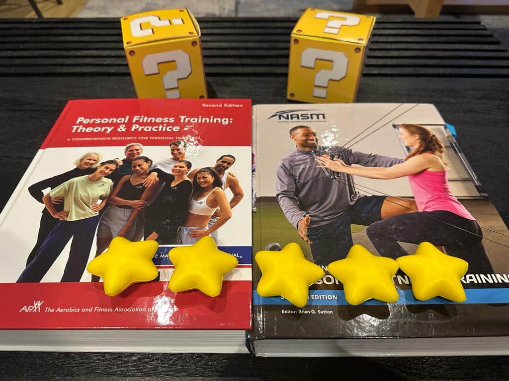 NASM vs AFAA - textbooks on table with yellow stars and question mark boxes - which cpt is best overall?