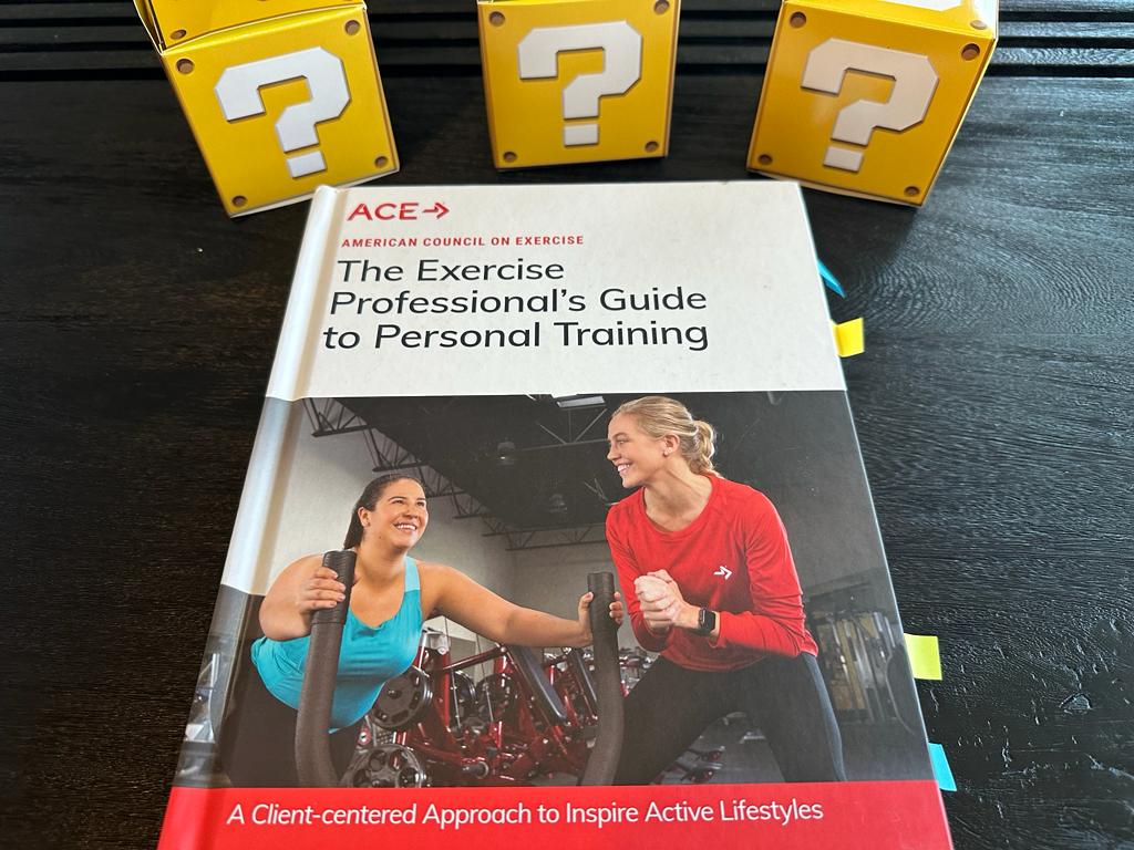 Updated: How to pick the best personal trainer certification 52 ACE CPT - Best Personal Trainer Certification programs - ACE textbook laid out with yellow question boxes behind it
