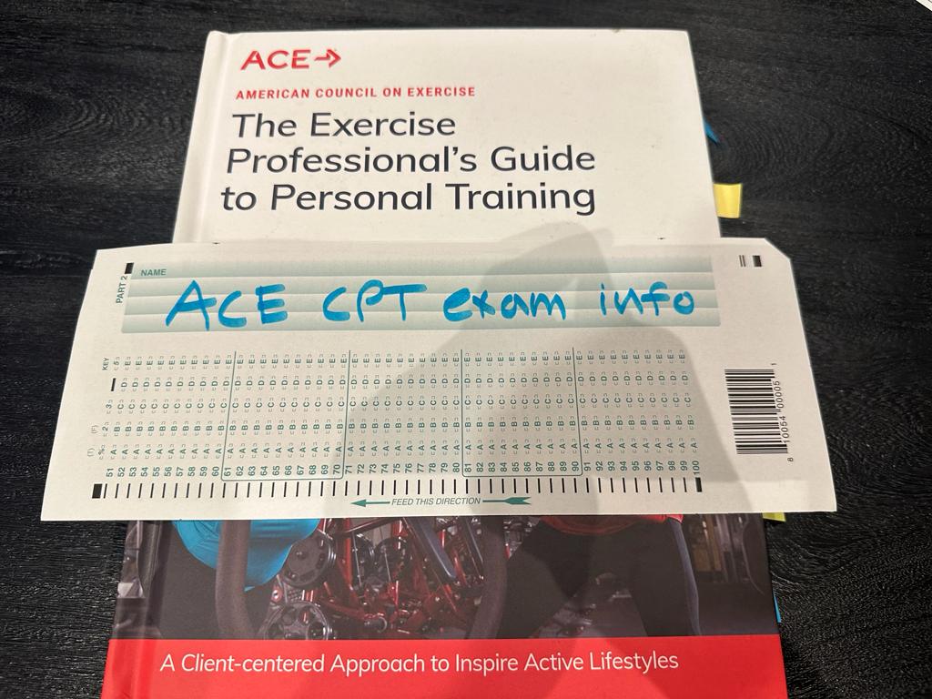 ACE CPT Exam Info - Pass Rate, Costs, and More 4 ACE personal trainer textbook on table with ACE exam info for preparation for the CPT exam.