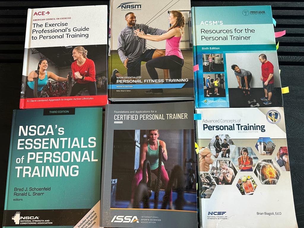 Updated: How to pick the best personal trainer certification 32 Best personal trainer certifications - textbooks lined up on table