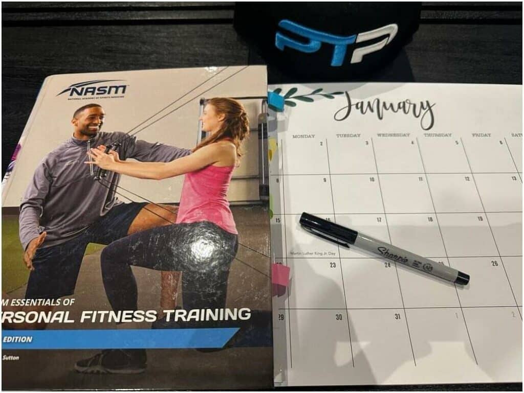 FREE NASM Study Plan, Study Calendar + Blueprint 4 Free NASM Study Plan, Study Calendar, and Blueprint - NASM textbook next to a calendar preparing the study blueprint