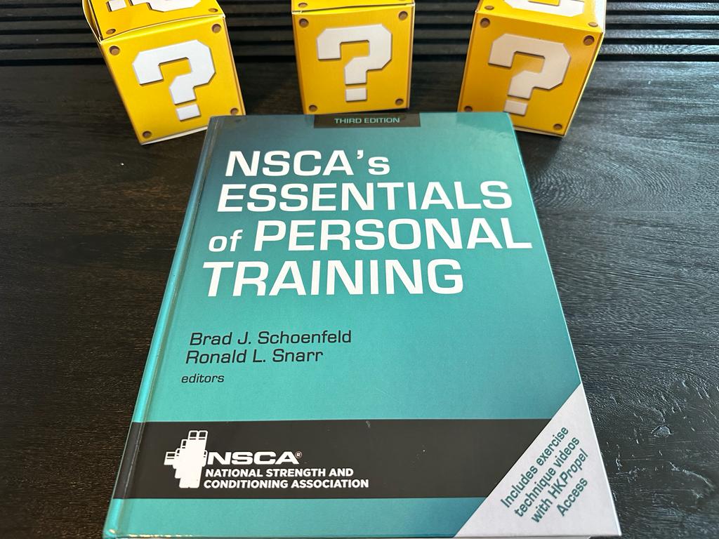 Updated: How to pick the best personal trainer certification 57 NSCA CPT - Best Personal Trainer Certification programs - NSCA textbook laid out with yellow question mark boxes
