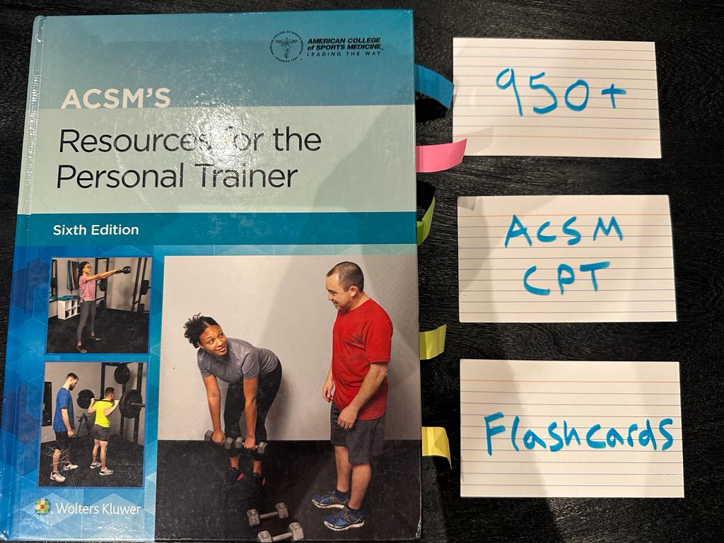 Free ACSM CPT Flashcards - Over 950 cards 3 acsm flashcards - ACSM textbook laid on table with acsm flashcards to study for the acsm cpt