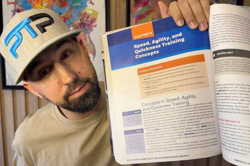 Tyler Read opening NASM textbook to Speed, Agility, and Quickness training 