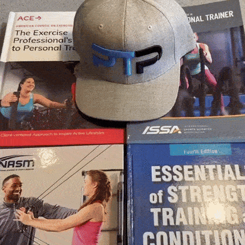 Tyler Read opens NASM CPT book to information on TDEE