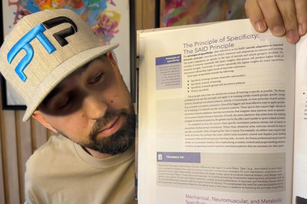 Tyler Read holds up NASM textbook with page on SAID principle